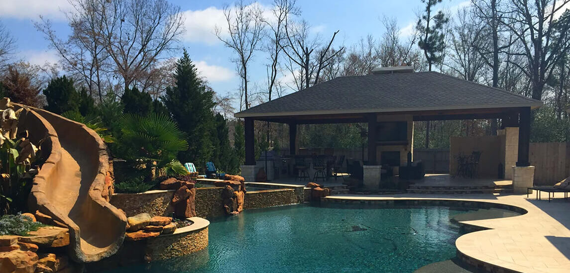 Creekstone Outdoor Living Full Outdoor Space with cabana, pool and stone slide